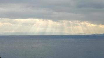 Sea scenery, with clouds and sunrays photo