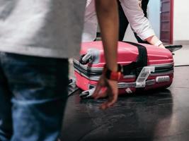 Close-up of pink trolley bag at the airport photo