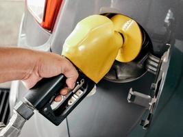 Close-up view of a hang holding a fuel pump at a gas station photo