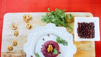 The girl tastes pkhali. Pkhali traditional Georgian food. Beetroot is used for the purple color. Walnut is used for decoration video