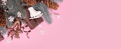 Pine trees branches with Cristmas New Year decoration top view, flat lay on pink background with copy space. Blank greeting card photo