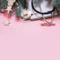 Medical Christmas background with copy space. Medical tools and Christmas decorations and snow top view photo