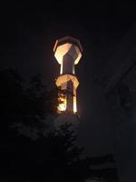 minaret of the mosque at night yellow light photo