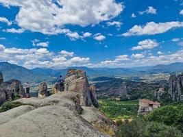 People enjoy the spectacular view of the Meteora rock formations hosting Orthodox Christian monasteries in Greece photo