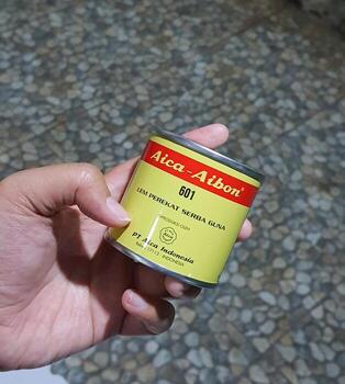 Central Java, Indonesia in October 2022. A hand holding Aica Aibon glue. photo