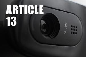 A modern web camera on monitor and article 13 inscription photo