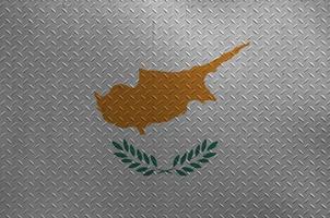 Cyprus flag depicted in paint colors on old brushed metal plate or wall closeup. Textured banner on rough background photo