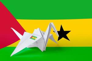 Sao Tome and Principe flag depicted on paper origami crane wing. Handmade arts concept photo
