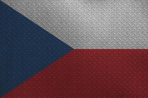 Czech flag depicted in paint colors on old brushed metal plate or wall closeup. Textured banner on rough background photo