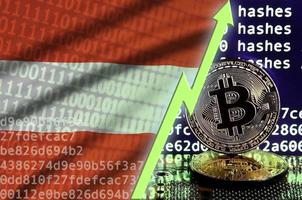 Austria flag and rising green arrow on bitcoin mining screen and two physical golden bitcoins photo