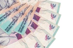 Los billetes de 1000 rupias indonesias se encuentran aislados en fondo blanco con espacio de copia apilado en forma de abanico de cerca foto