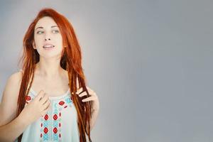 Red-haired girl with long dreadlocks. photo