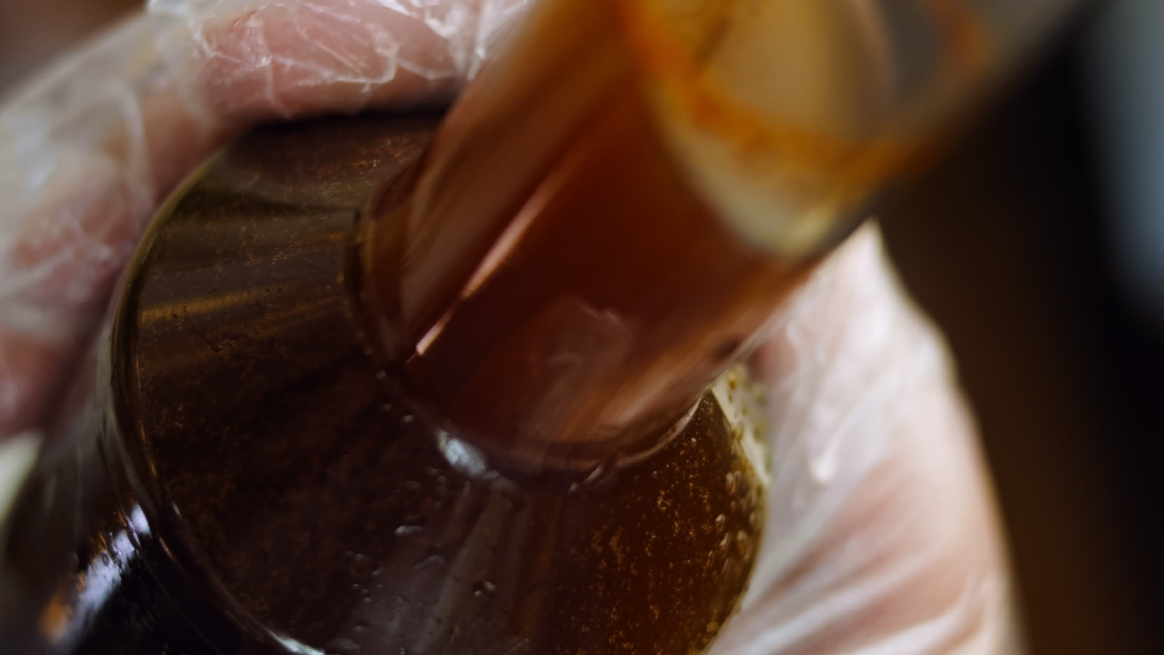 Macro filming of Worcestershire sauce. The chef pours the sauce into a