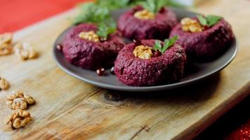The girl tastes pkhali. Pkhali traditional Georgian food. Beetroot is used for the purple color. Walnut is used for decoration video