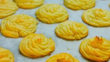 The chef makes potato cookies using a food bag. Potato cookies canonic recipe Brie, parmesan and Heavy cream. Macro shooting video