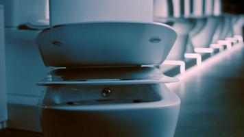 Rotating washbasin. Studio filming. In the background a row of toilets. 4k video