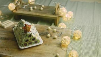 Cake with green dough, sour cherries and sour cream. It also has food ornament and the red star cake video