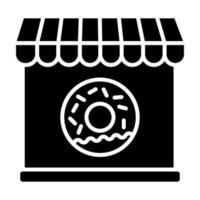 icono de glifo de tienda de donas vector