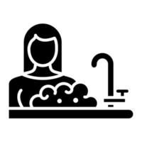 icono de glifo de mujer lavando platos vector