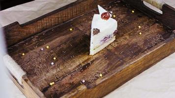 Delicious cherry cake on a wooden tray with decorations video