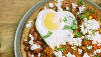 Huevos rancheros with heart-shaped egg. Mexican atmosphere video