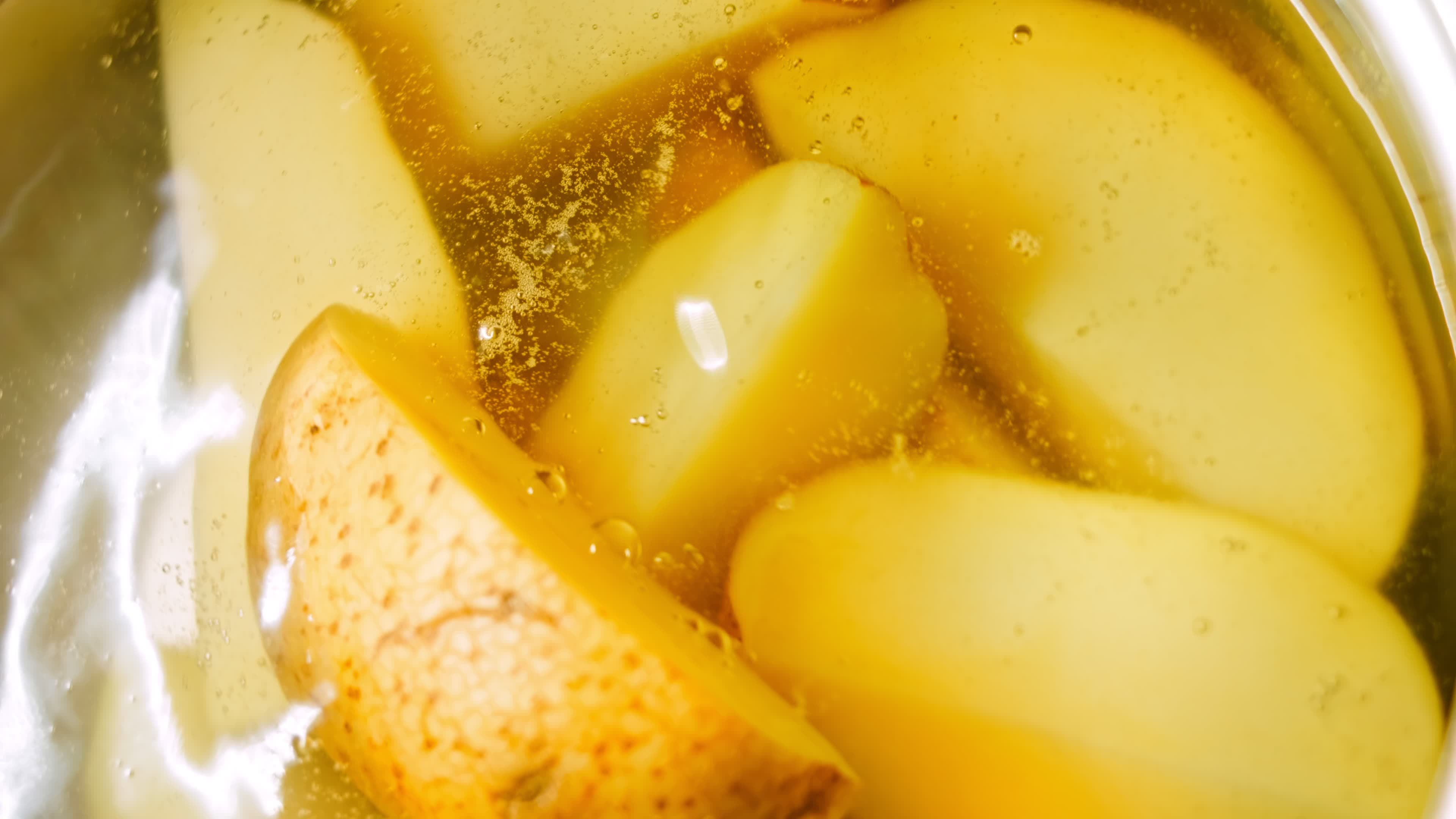 Boil the potatoes in an iron bowl. Macro shooting on intense steam