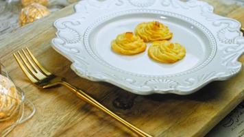 Potato cookies canonic recipe Brie, parmesan and Heavy cream. It is used to decorate retro plate and gold fork