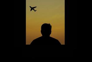 man alone looking at the plane through the window and silhouette photo
