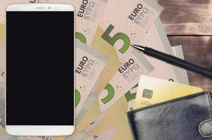 5 euro bills and smartphone with purse and credit card. E-payments or e-commerce concept. Online shopping and business with portable devices photo