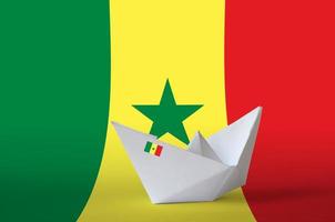 Senegal flag depicted on paper origami ship closeup. Handmade arts concept photo