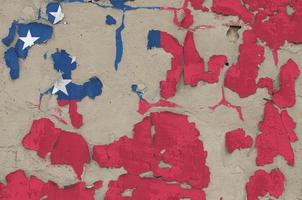 Samoa flag depicted in paint colors on old obsolete messy concrete wall closeup. Textured banner on rough background photo