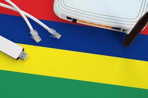 Mauritius flag depicted on table with internet rj45 cable, wireless usb wifi adapter and router. Internet connection concept photo