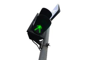 Traffic lights with the green light lit isolated on white photo