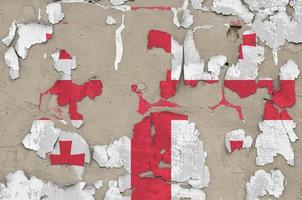 Georgia flag depicted in paint colors on old obsolete messy concrete wall closeup. Textured banner on rough background photo