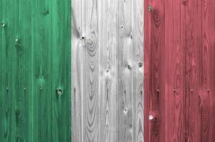 Italy flag depicted in bright paint colors on old wooden wall. Textured banner on rough background photo