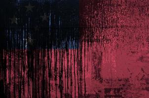 Samoa flag depicted in paint colors on old and dirty oil barrel wall closeup. Textured banner on rough background photo