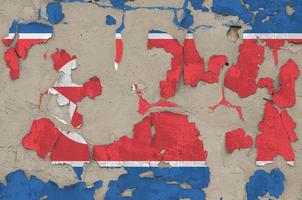 North Korea flag depicted in paint colors on old obsolete messy concrete wall closeup. Textured banner on rough background photo