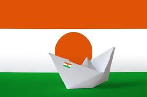 Niger flag depicted on paper origami ship closeup. Handmade arts concept photo