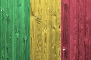 Mali flag depicted in bright paint colors on old wooden wall. Textured banner on rough background photo