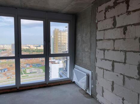 New apartment, new building without finishing and repair, with free planning and walls made of concrete, bricks and gas silicate blocks without partitions and with large panoramic windows photo