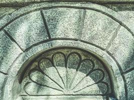 stone texture, material for making walls of houses in foreign countries. a flower is engraved on the arch, the texture of the stone photo
