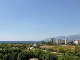 ariel panoramic view of old city and skyscrapers with the sea from the mountains photo