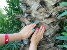 Woman hand on tree trunk. Concept of save environment or unity photo