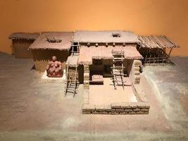 A small clay model of an ancient building in a museum photo