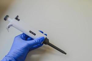 Young attractive woman work with PCR dispenser in the laboratory of genetics photo