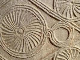 Stone background with volumetric spiral pattern, top view photo