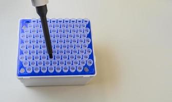 mechanical dispenser for setting test tubes. dispenser with multiple tips for easy analysis. the dispenser puts the test tube in place of the research. laboratory diagnostics photo