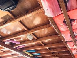 wooden ceiling in the house. wooden beams are mounted on the ceiling, next to the carcass fabric, an awning with waterproof material is stretched photo