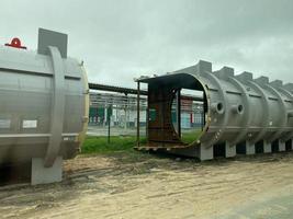 Large metal iron distillation column for separation of substances into fractions in the industrial premises photo
