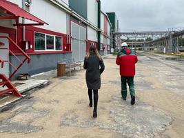 back view shot factory workers or engineers talking and planing for a job in containers warehouse storage photo